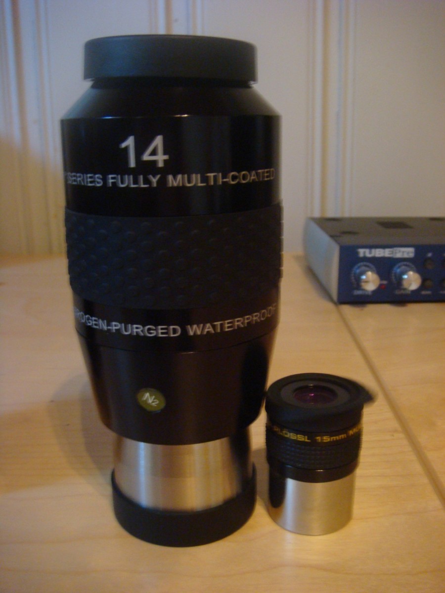 The Explore Scientifc 14mm 2" beside its counterpart, dwarfing the 15mm Meade series 4000 1.25 ep.